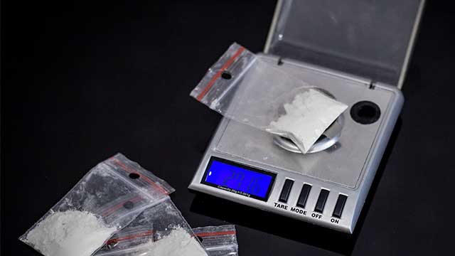 meth being weighed on a scale - What Is A Teener Of Meth?