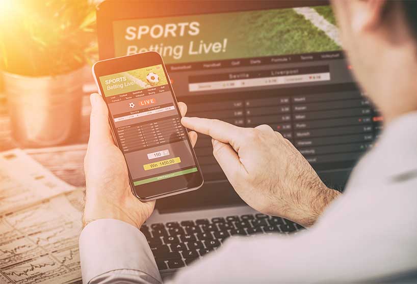 Man Betting On A Sporting Event-Sports Betting & Gambling Addiction In Massachusetts