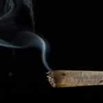 A hand rolled cigarette with a plume of smoke coming from it - Can You Smoke Ritalin (Methylphenidate)