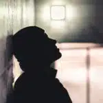 A silhouette of a man in a dark hallway - Dexedrine Withdrawal Symptoms Timeline & Detox