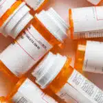 Multiple orange prescription bottles lie next to each other - Is Ritalin (Methylphenidate) A Stimulant