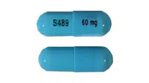 A blue Vyvanse capsule with S489 and 60mg printed on the side