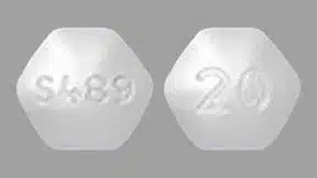 A hexagonal chewable Vyvanse tablet with S489 printed on one side and 20 on the other