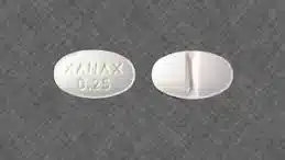 An oval Xanax with the word Xanax and a 0.25 imprinted in it