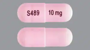 A pink Vyvanse capsule with S489 and 10 mg printed on it