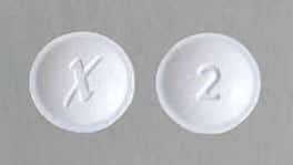 A round Xanax pill with an X and 2 imprinted into it