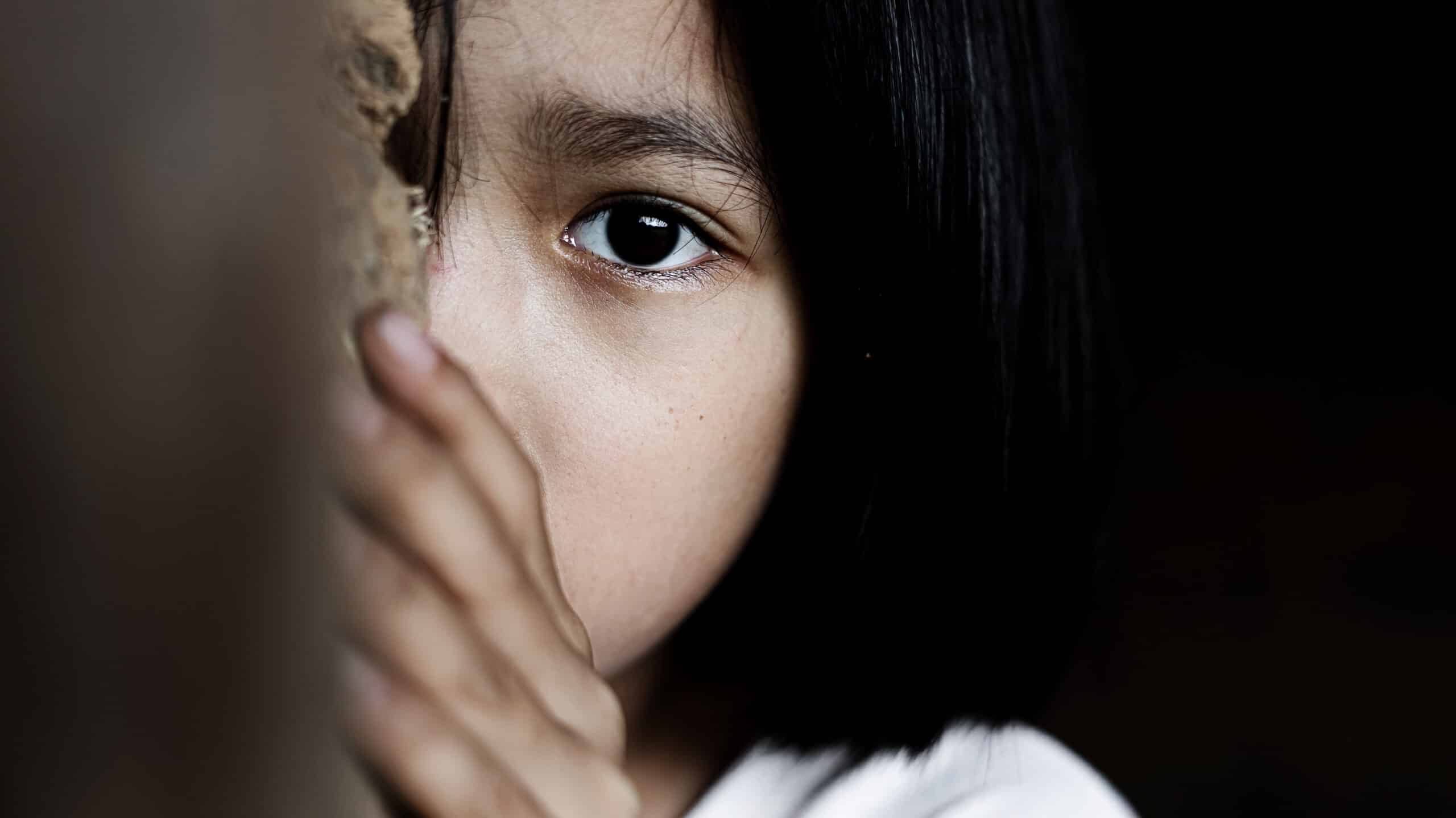 A little girl looks around a corner - The Effects Of Meth On Children In Massachusetts