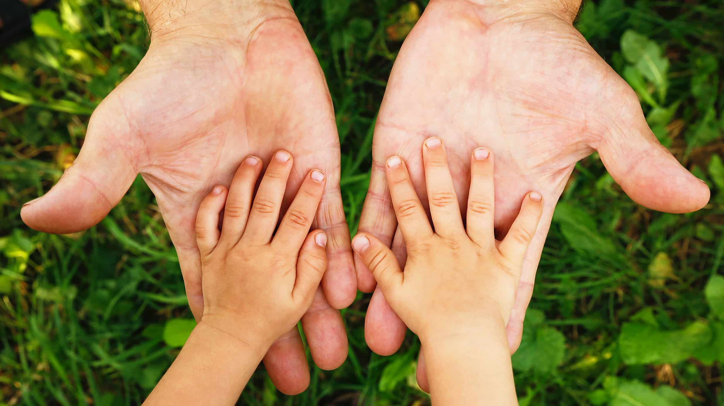 A child put their hands in their parent's hands - The Impacts of Parental Substance Abuse On Children