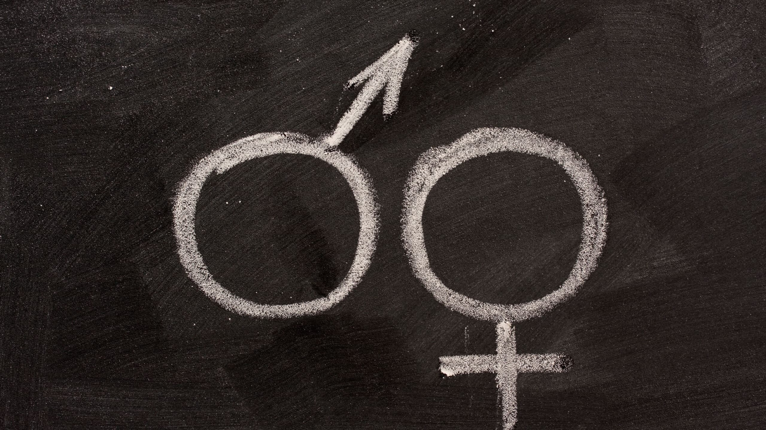 The male and female symbols are drawn on a chalkboard - Why Rehab Centers Separate Men & Women